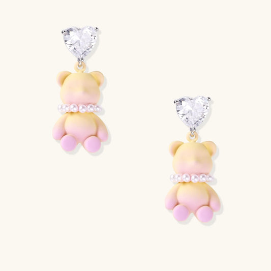 Dangle earrings with heart-cut zirconia studs and pastel teddy bear charms with pearl necklace details